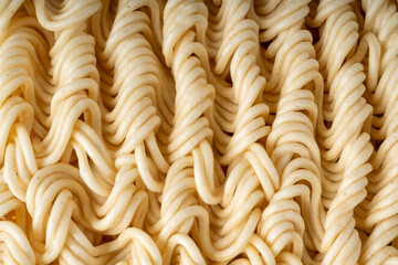 Instant noodles texture background, dry ramen noodle macro pattern