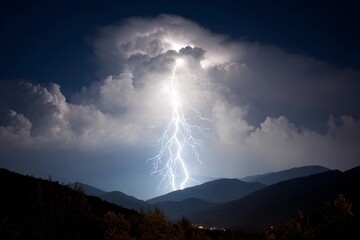Lightning strikes over mountains during night sky