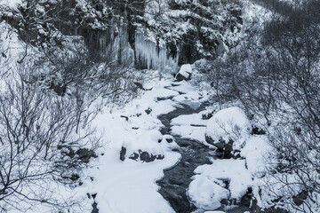 Frozen winter view of Magnusarfoss waterfall, Iceland.