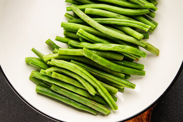 Green beans raw fresh vegetable string bean healthy food ingredient appetizer fresh tasty gourmet food background on the table rustic top view copy space keto and paleo diet vegetarian and vegan food