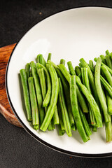 Green beans raw fresh vegetable string bean healthy food ingredient appetizer fresh tasty gourmet food background on the table rustic top view copy space keto and paleo diet vegetarian and vegan food