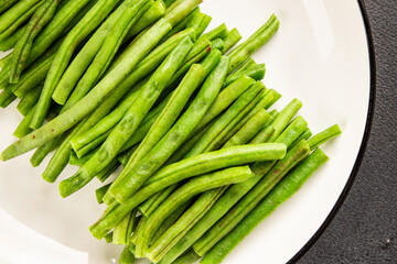 Green beans raw fresh vegetable string bean healthy food ingredient appetizer fresh tasty gourmet food background on the table rustic top view copy space keto and paleo diet vegetarian and vegan food