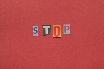 Stop word made from cutout letters on a red background