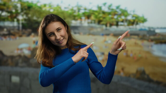 Woman enjoying seaside scene in blue sweater at beach with ocean in background showcasing outdoor fun and tranquility. - Powered by Adobe