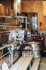 Trois-Rivieres, Canada - August 16, 2025: Interior view of a traditional maple syrup production facility in Saint-Mathieu-du-Parc, showing stainless steel evaporator equipment, pipes, barrels
