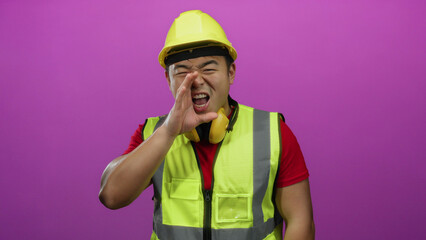 Construction worker wearing safety gear shouts against a vibrant pink background, expressing energy and command.