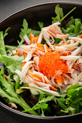 Crab meat salad, red caviar, green salad mix healthy food main course ingredient appetizer fresh tasty table setting gourmet food background on the table rustic food top view copy space pescetarian  