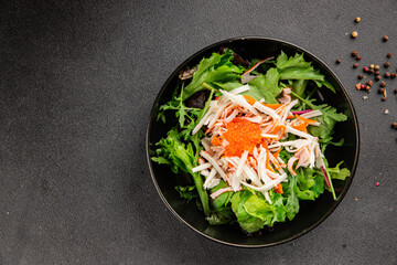 Crab meat salad, red caviar, green salad mix healthy food main course ingredient appetizer fresh tasty table setting gourmet food background on the table rustic food top view copy space pescetarian  