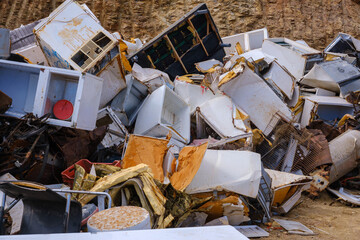 Abandoned and broken appliances in a junk yard setting