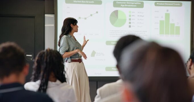 Business woman, graphs and presentation for speaker in seminar room with audience. Education, forum speech and statistics with corporate growth for public speaking, strategy and convention with crowd