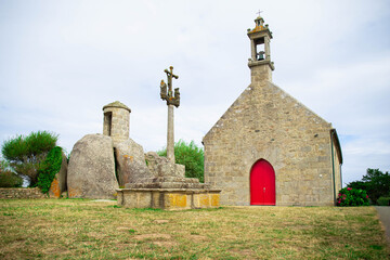 Chapelle Pol, a small granite church in Brignogan-Plages, Brittany, France. and the nearby calvary cross and sentry box carved in the rock.