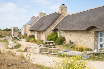 The fairytale thatched cottages located in the old fishermen village of Meneham, Brittany, France. Side view, no people.