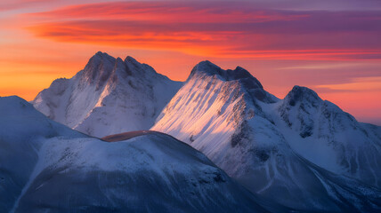 A breathtaking view of snow capped mountain peaks bathed in the warm vibrant hues of a stunning sunrise creating a majestic landscape