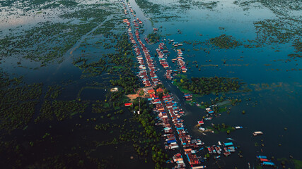 Kampong Phluk floating village with stilt houses on Tonle Sap lake in Cambodia.