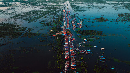 Kampong Phluk floating village with stilt houses on Tonle Sap lake in Cambodia.