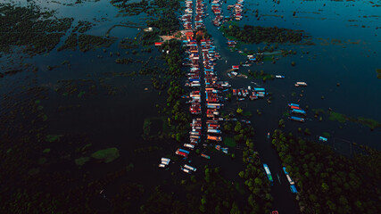 Kampong Phluk floating village with stilt houses on Tonle Sap lake in Cambodia.