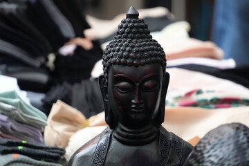 Black Buddha Statue Surrounded by Meditation Accessories