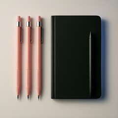 Stylish stationery still life with pink pens and a black notebook on a beige background. Concept of creativity, organization, and a modern workspace.