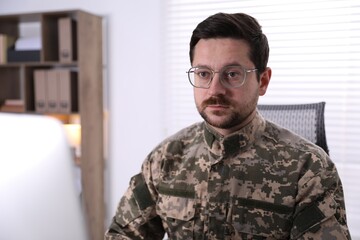Fototapeta premium Military man working on computer in office