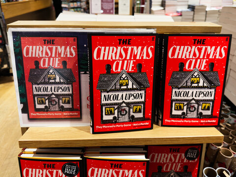 The Christmas Clue by Nicola Upson on a festive bookstore display featuring mystery novels