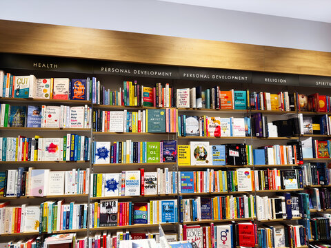 Bookshelf full of colorful self help and health books in a library display