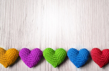 Valentine's Day. multicolored knitted hearts on a grey background. Flat lay.