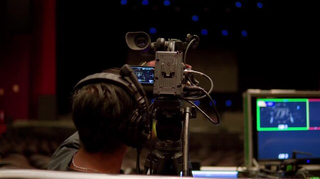 Professional cameraman operating a broadcast camera during a live event