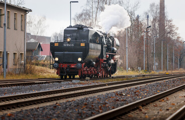 old steam train Dampflok with a lot of steam in saxony bischofswerda 528141-5 Dampflok