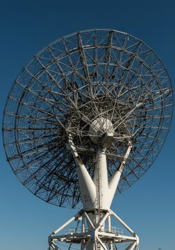 Large parabolic dish antenna installation pointed towards the open sky, designed for receiving broadcast signals and digital communication data transmission, equipment, modern, receiver