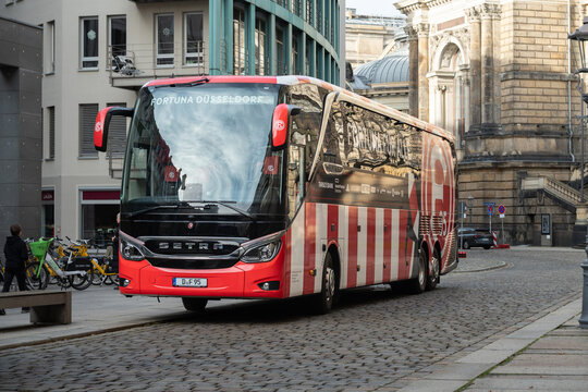 DRESDEN, GERMANY - 30. November 2025: Fortuna D&uuml;sseldorf coach of the football club in the inner city. Red and white colored bus with a large logo sign of the team.