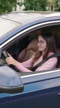 VERTICAL VIDEO: Woman Driver Fastens The Seat Belt In The Car Before Driving, Safety First, Preparing To Drive, Focused On Secure Travel and Responsible Griving Habits. Road Safety Regulations Concept