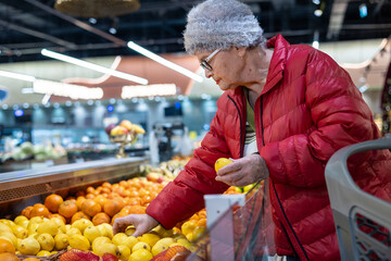 Elderly Woman Choosing Fresh Lemons at Supermarket Produce Section – Active Senior Lifestyle, Healthy Eating and Independent Shopping