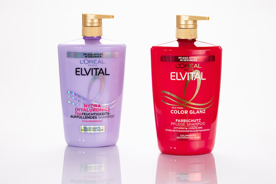 Two L&rsquo;Or&eacute;al Elvital shampoo bottles, Hydra Hyaluronic and Color Glanz, photographed in studio on a white background, showing product packaging and branding for editorial beauty content.
