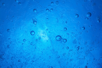 Ice texture. Frozen bubbles in ice. Blue abstract