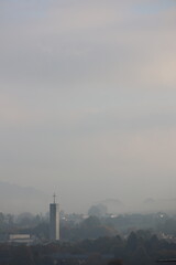 Cloudy sky with a tall building in the background