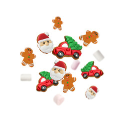 Christmas cookies and marshmallows flying in air on white background