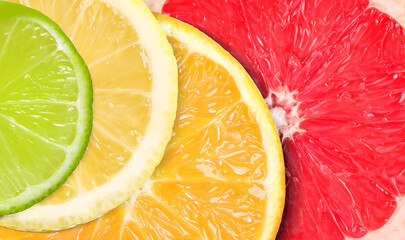 Citrus fruits as background. Slices of orange, lime, lemon and grapefruit, top view