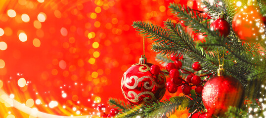 Christmas greeting card. Fir tree with festive balls and bokeh lights on red background, banner...