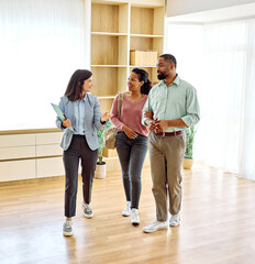 Female Real Estate Agent Selling And Showing The Modern Apartment To His Young Clients That Are...