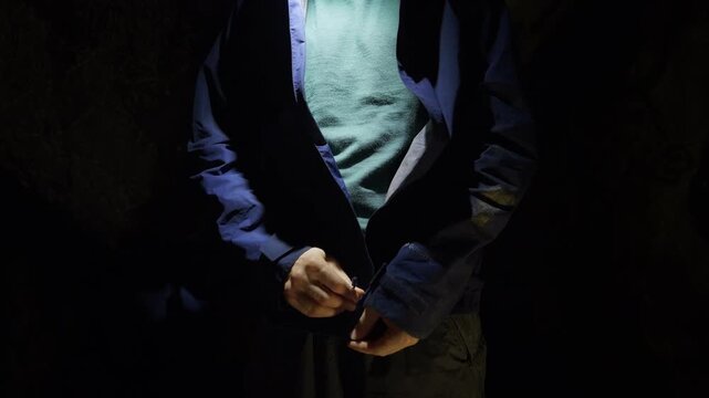 Explorer Zipping Jacket Inside Dark Cave