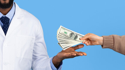 A medical professional in a white lab coat is receiving cash from a hand. The setting is bright with a blue background, suggesting a transaction taking place.