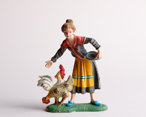 Antique small figurine: women feeding chickens