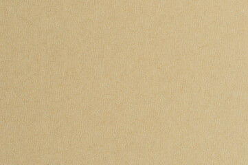 Texture of a plain brown paper sheet on a flat surface