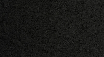 Dark surface with texture patterns in close range view during daylight