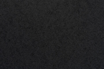 Close-up of textured dark surface in daylight