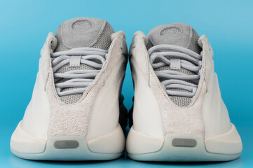 Sneakers displayed on a blue background for product viewing
