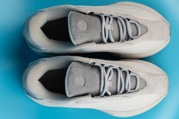 New sneakers display on a blue background with soft lighting