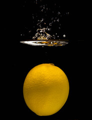 Yellow Lemon Suspended Under Water, Sharp Ring Splash And Delicate Bubble Trail Captured With...