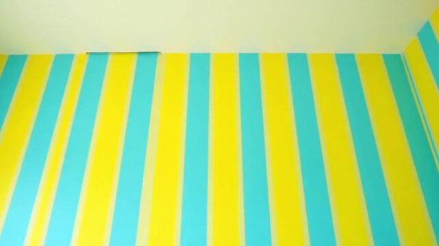 Bright yellow and cyan vertical stripes create a vibrant and playful background texture pattern