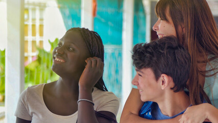 Teenager group of multi ethnic friends at school having fun piggybacking outdoors in the hallway